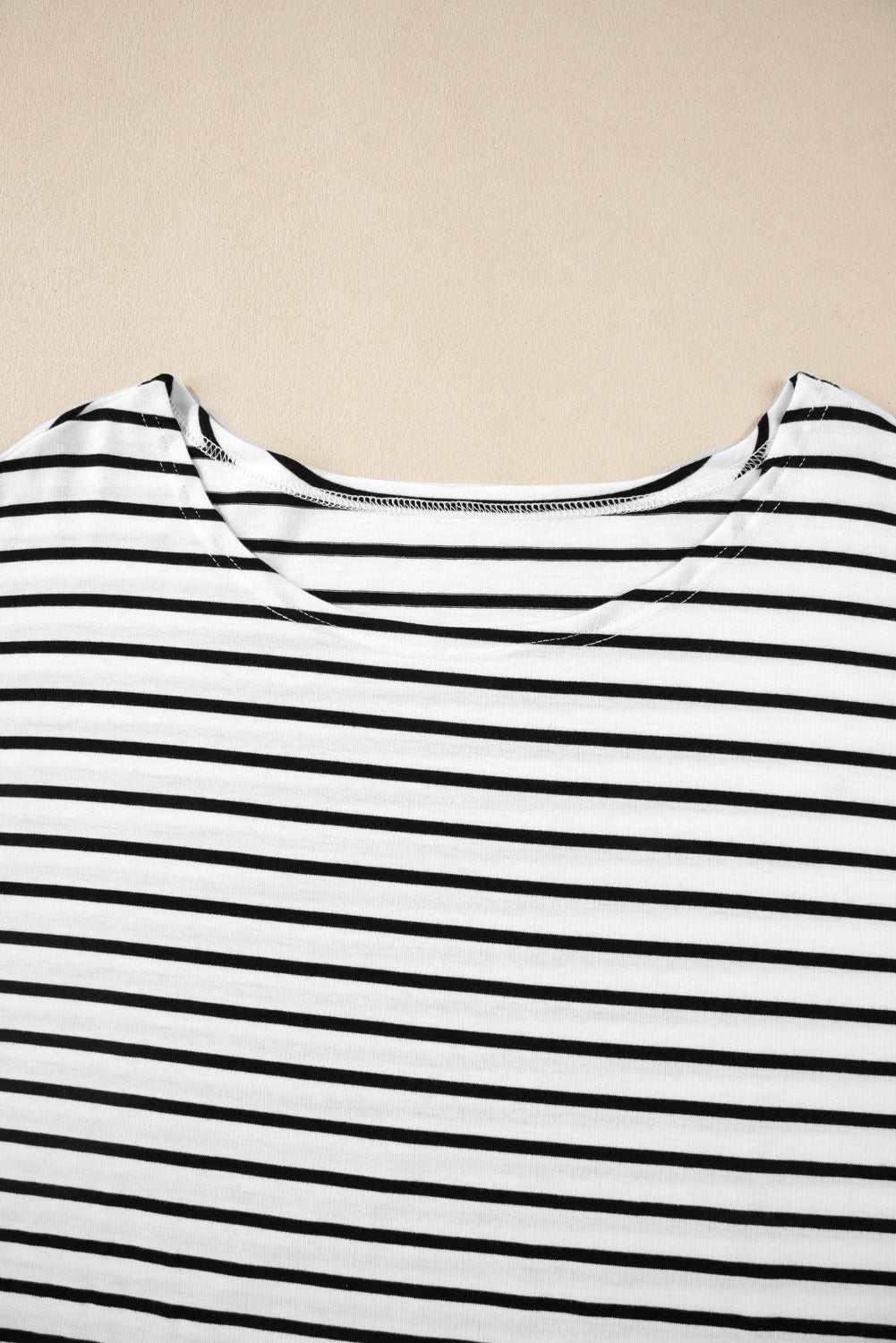 Stripe half sleeve scoop neck top with black and white pattern.