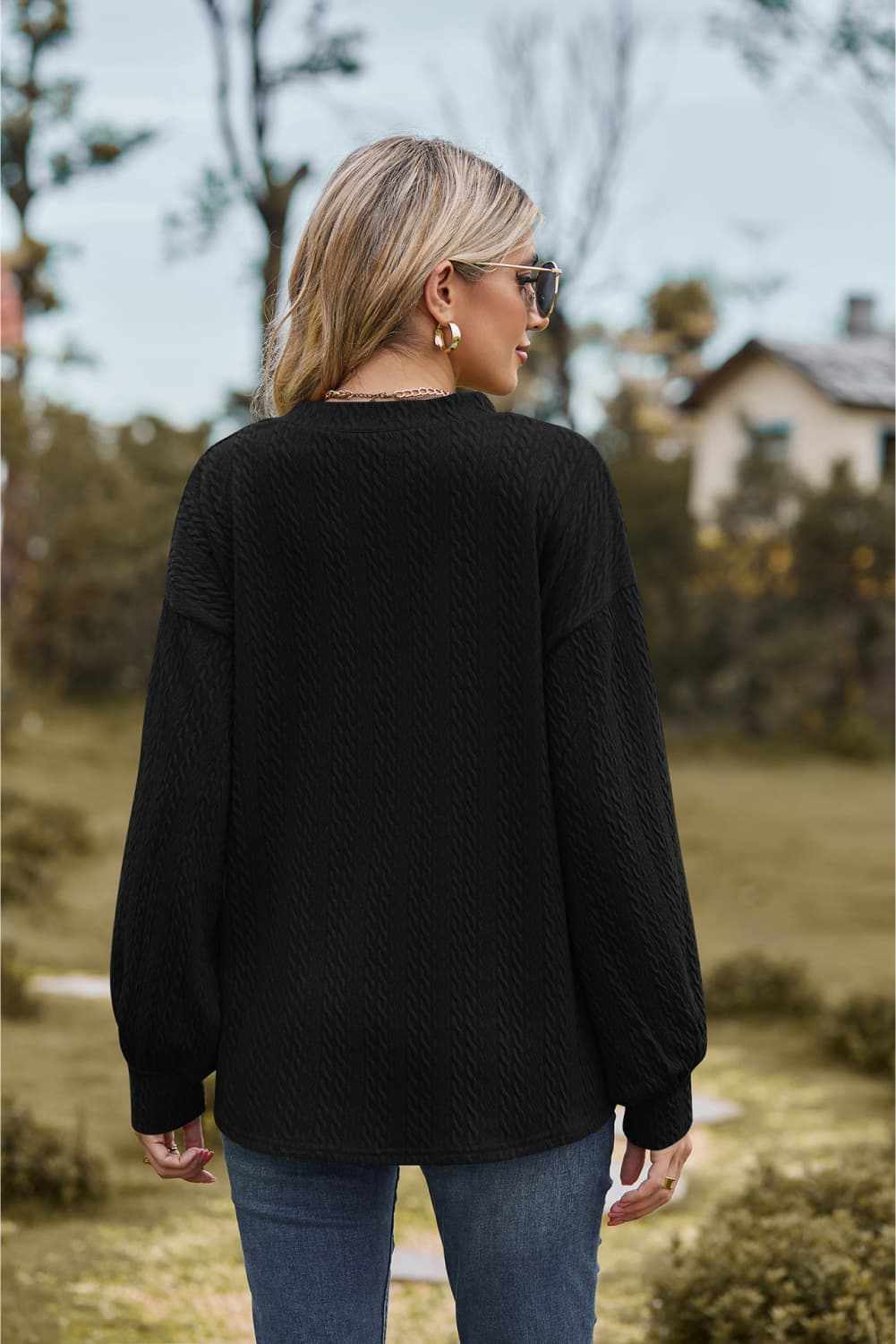 V-neck dropped shoulder blouse, solid black, casual style with long sleeves and slightly stretchy material.