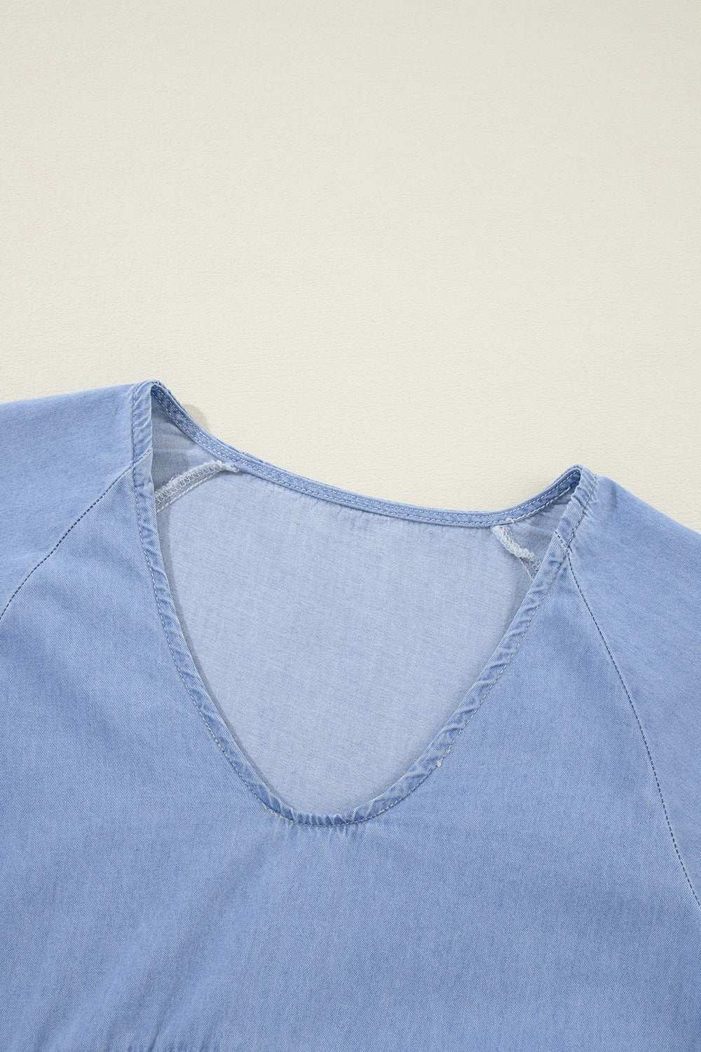 Blue V-neck tiered ruffled hem mini dress detail.