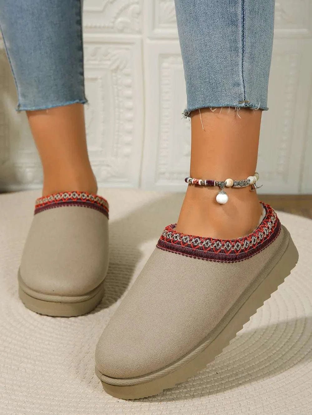 Round toe platform slippers with faux fur material and rubber sole.