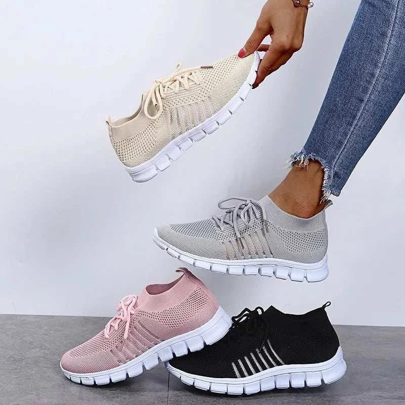 Breathable mesh lace-up sneakers in various colors displayed on a floor.