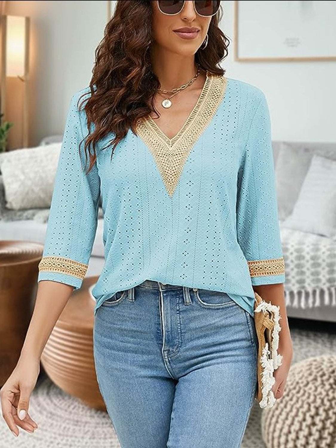 V-Neck Eyelet Blouse with three-quarter sleeves and delicate eyelet detailing in light blue.