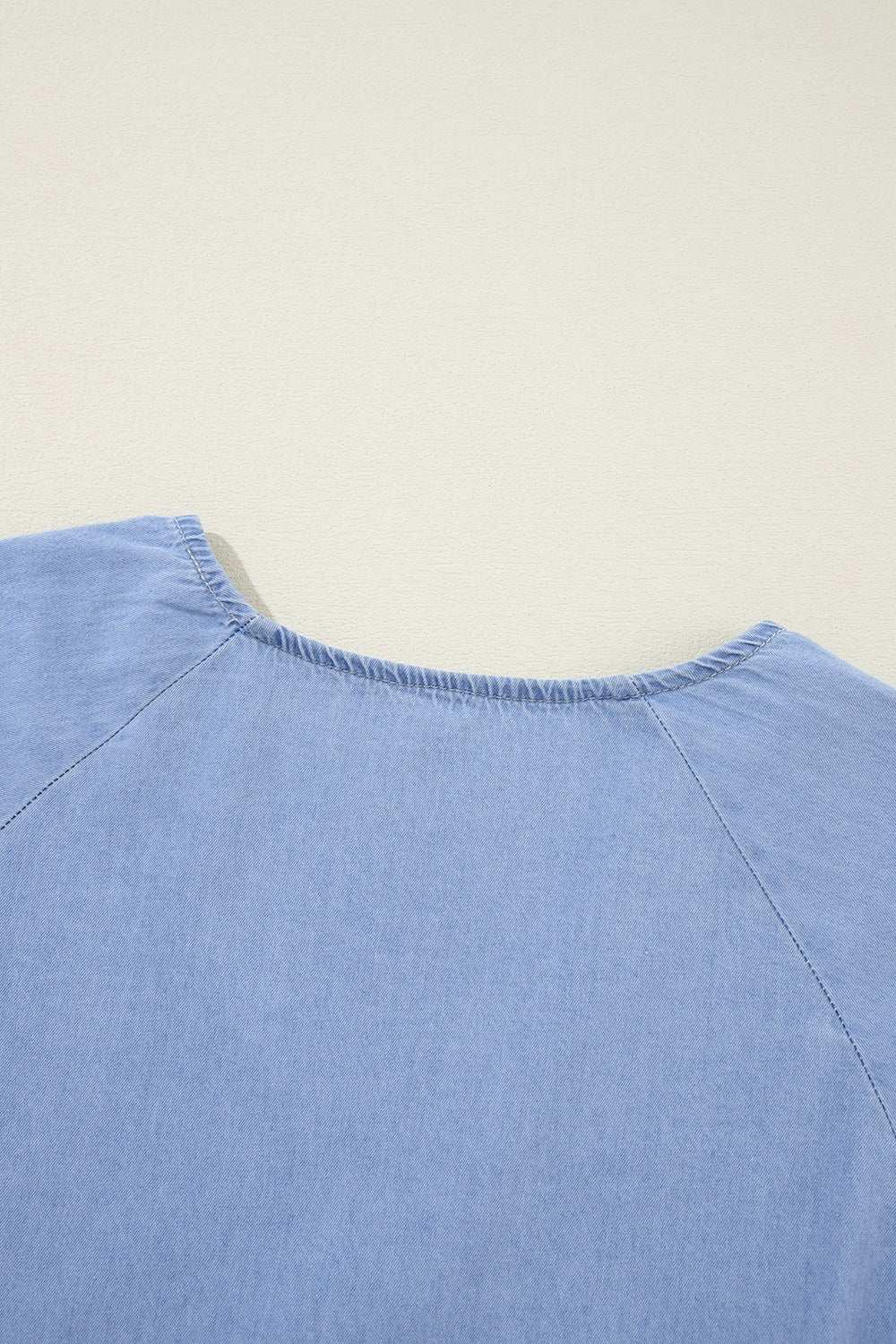 V-Neck Tiered Ruffled Hem Mini Dress, blue fabric close-up.