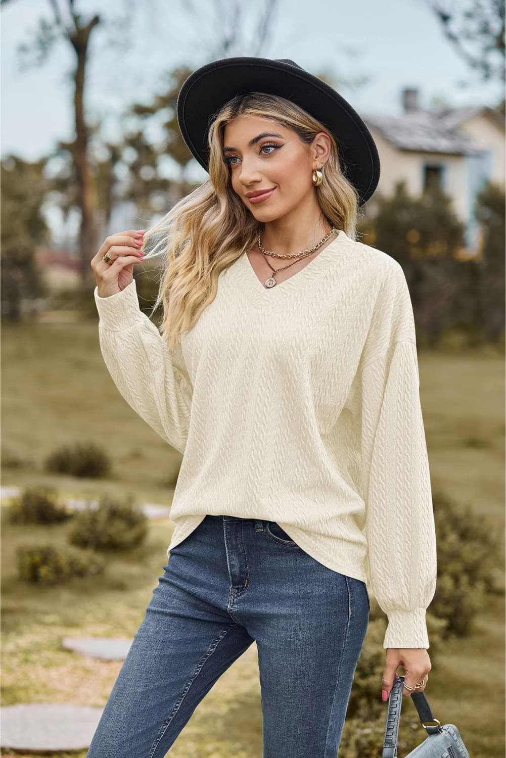 V-Neck dropped shoulder blouse with long sleeves in solid color, casual style.