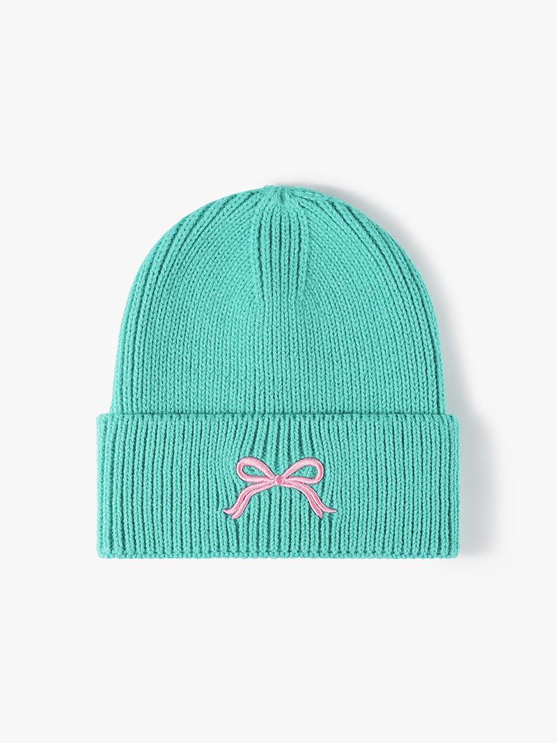 Teal embroidered bow knit hat made from acrylic material.