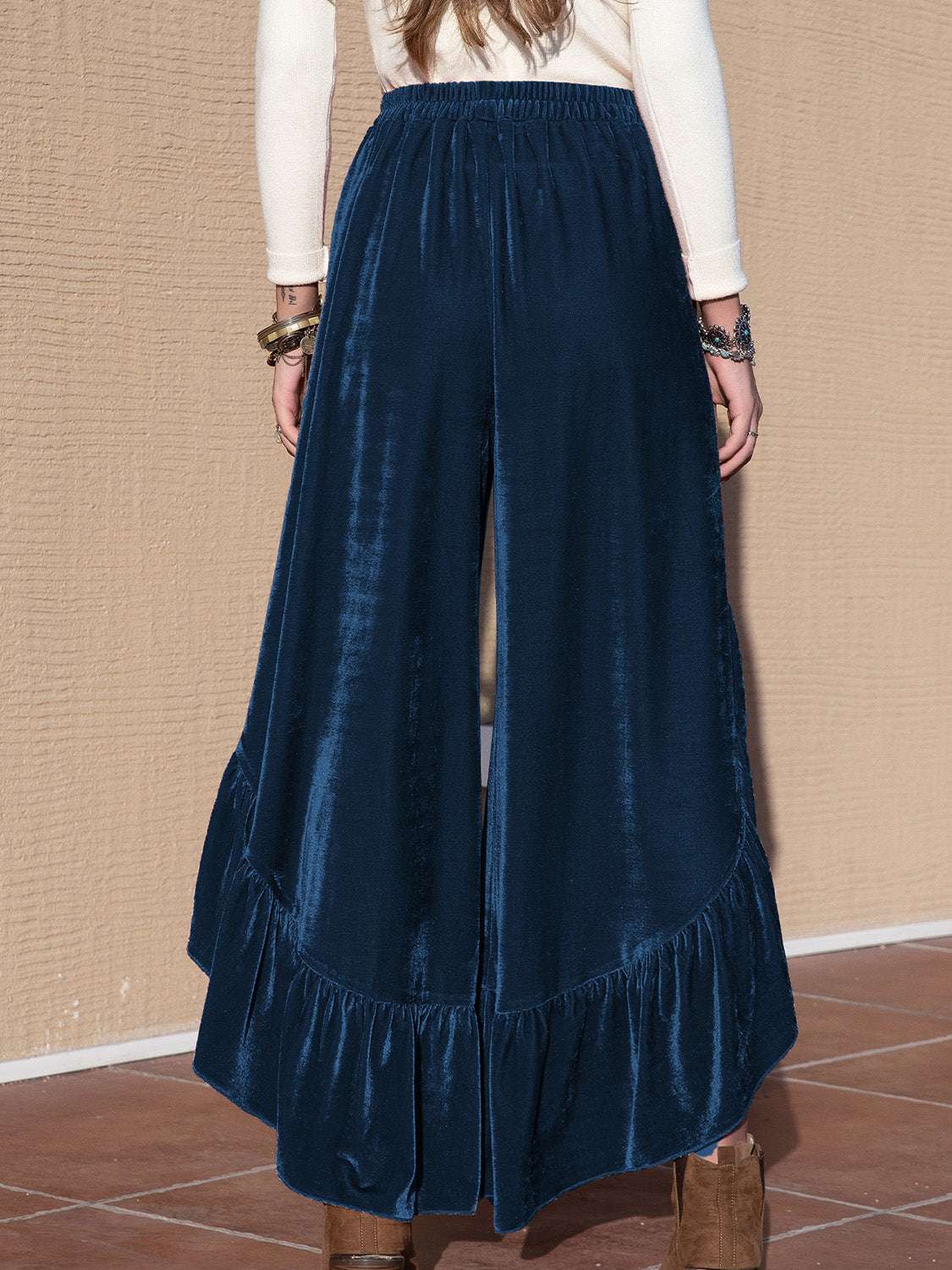 Slit ruffled wide leg pants in blue with elastic waistband.