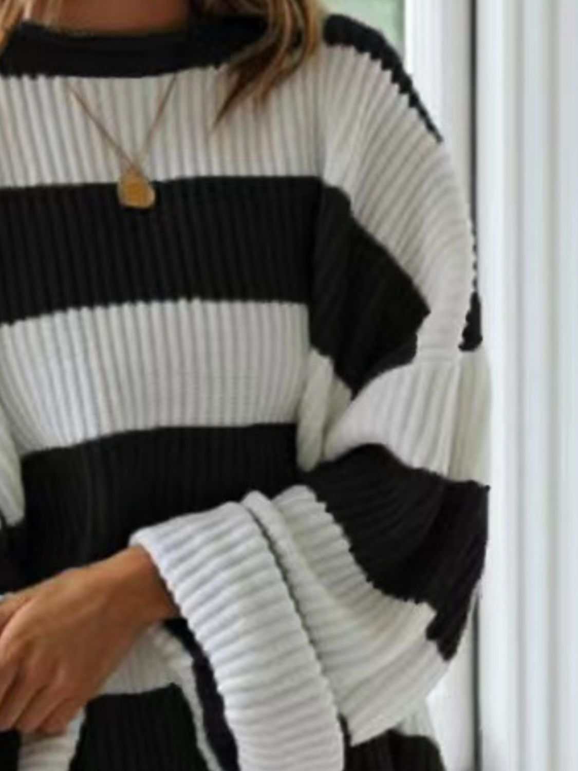 Black and white striped round neck long sleeve sweater, slightly stretchy with a cozy fit.