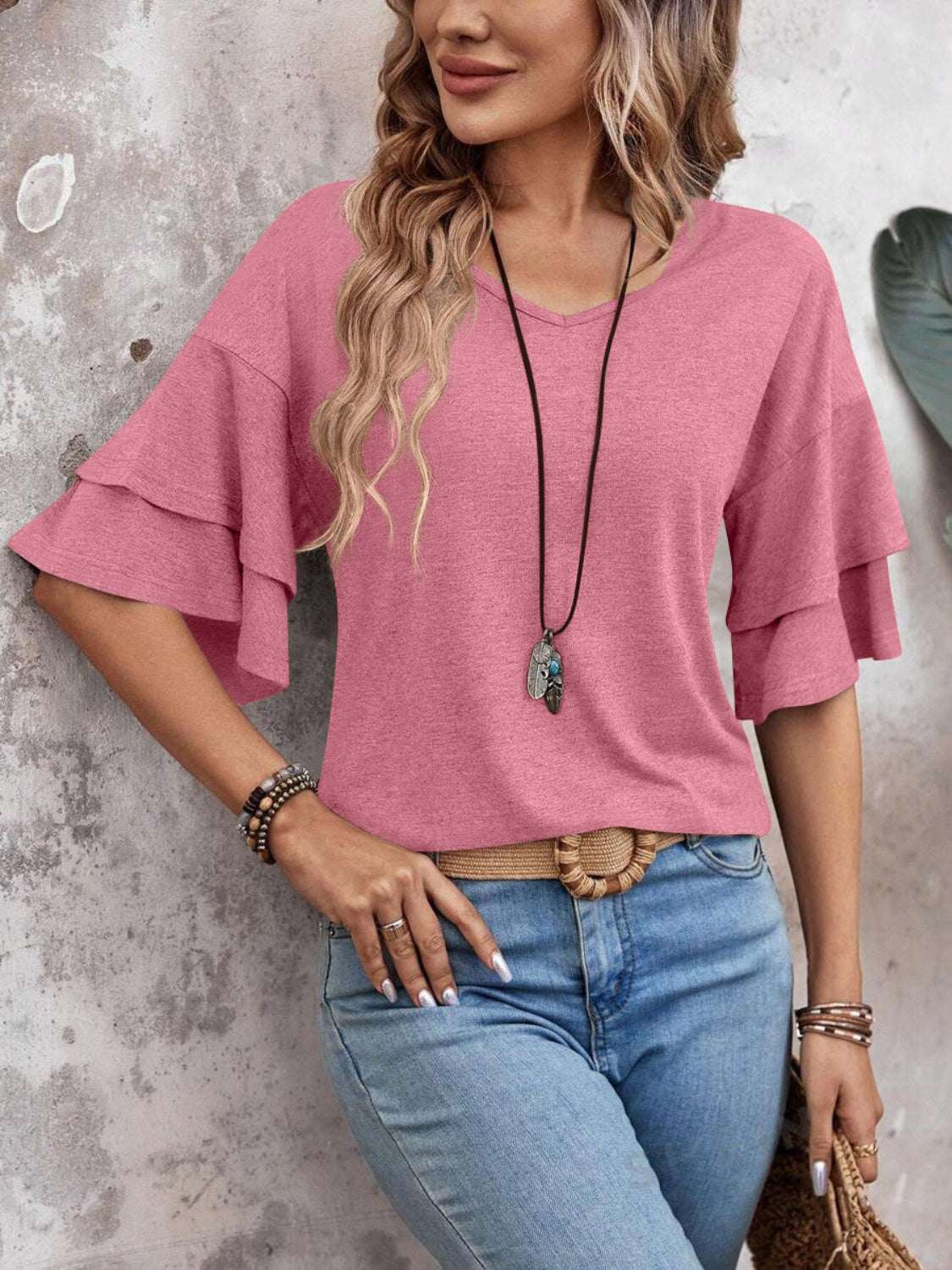 V-Neck half sleeve blouse in pink with slightly stretchy polyester-rayon blend.