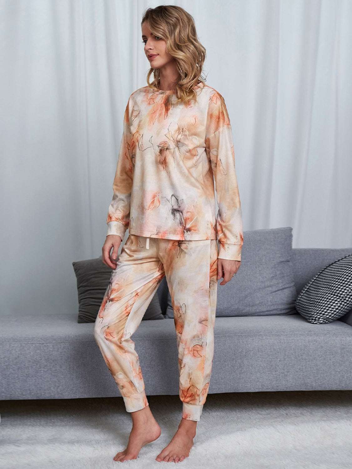 Shiny tie-dye round neck top and pants lounge set, slightly stretchy two-piece outfit in orange tones.