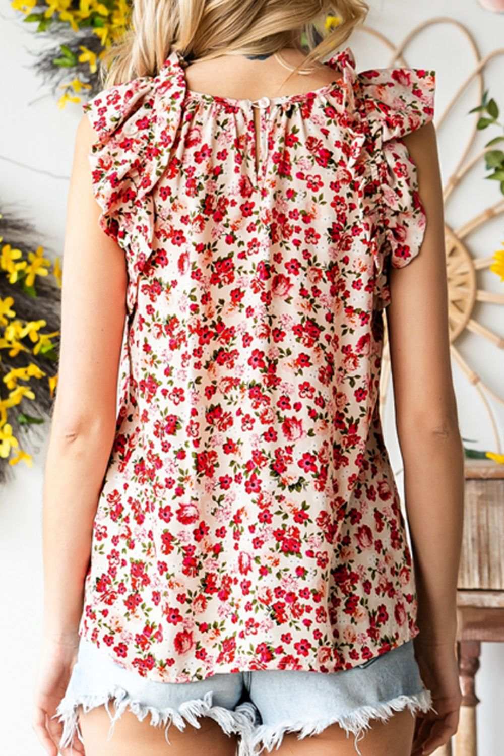 Ruffled floral round neck cap sleeve blouse in red and white, back view.