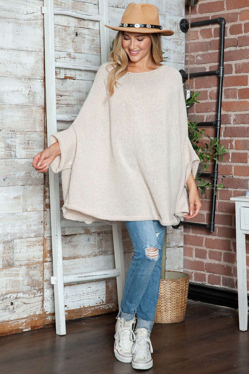 Round neck batwing sleeve sweater in beige on model, casual style.