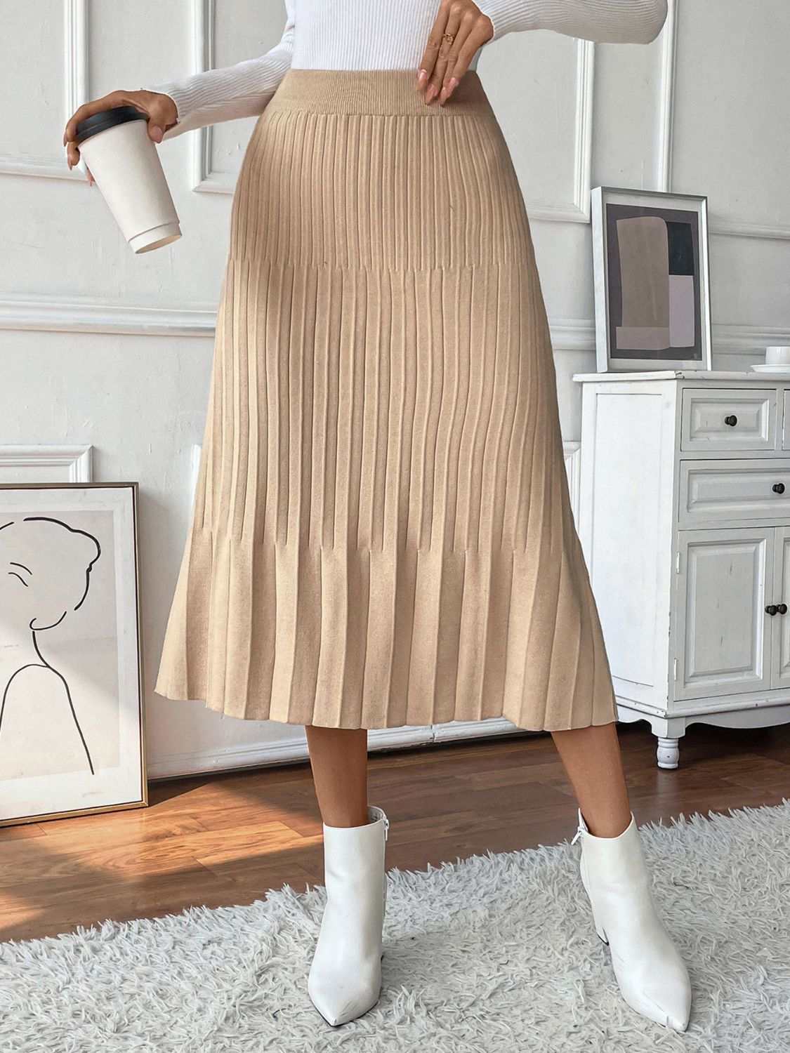Beige Perfee Pleated Midi Sweater Skirt in a stretchy material shown with a white top and boots.