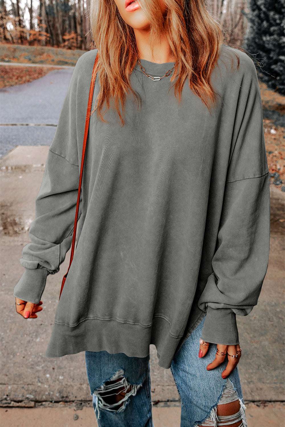 Dropped shoulder round neck long sleeve blouse in solid color, casual style.