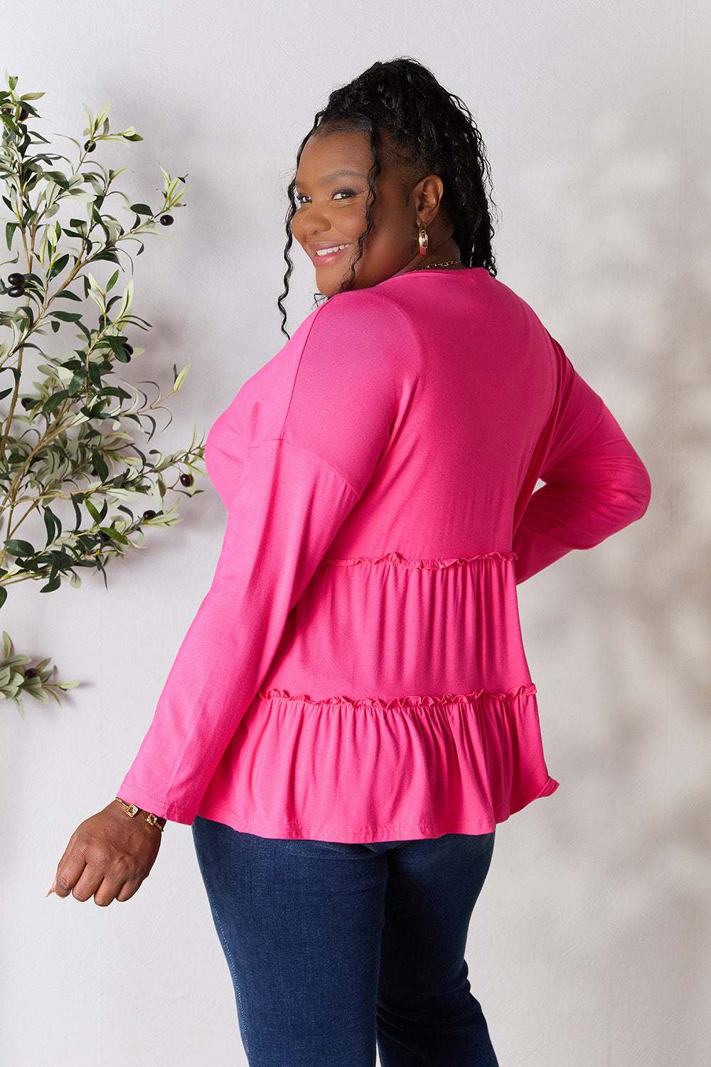 Half Button Long Sleeve Ruffle Hem Blouse in vibrant pink with a ruffled design.