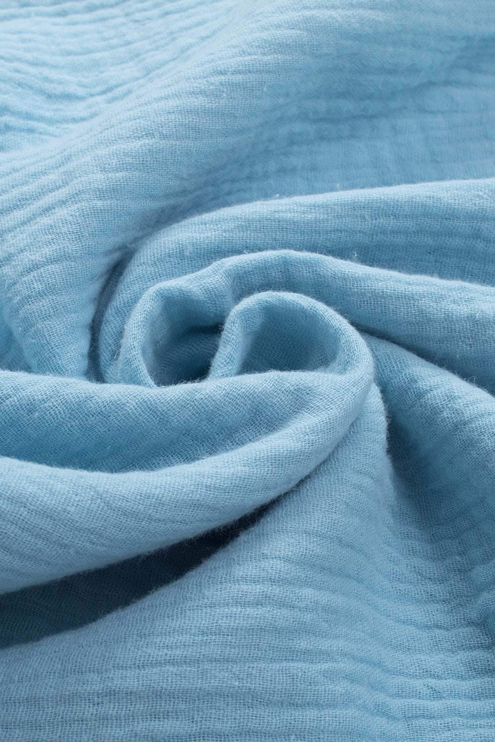 Light blue cotton fabric with a textured pattern, suitable for casual dropped shoulder V-neck blouse.