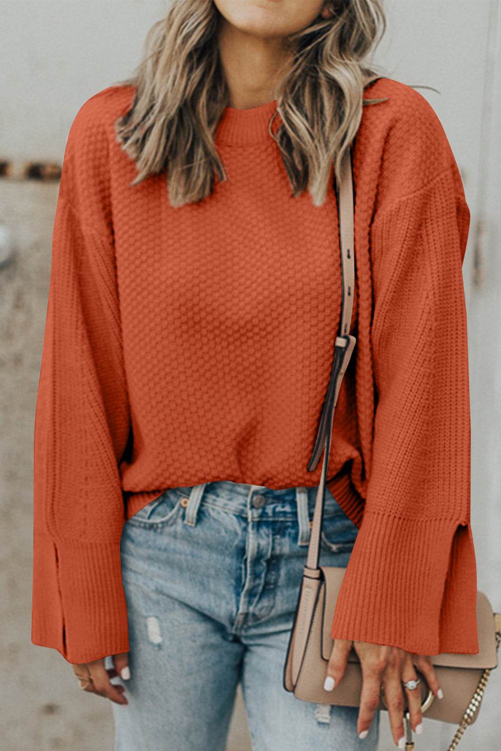 Textured round neck long sleeve sweater with slit detail.