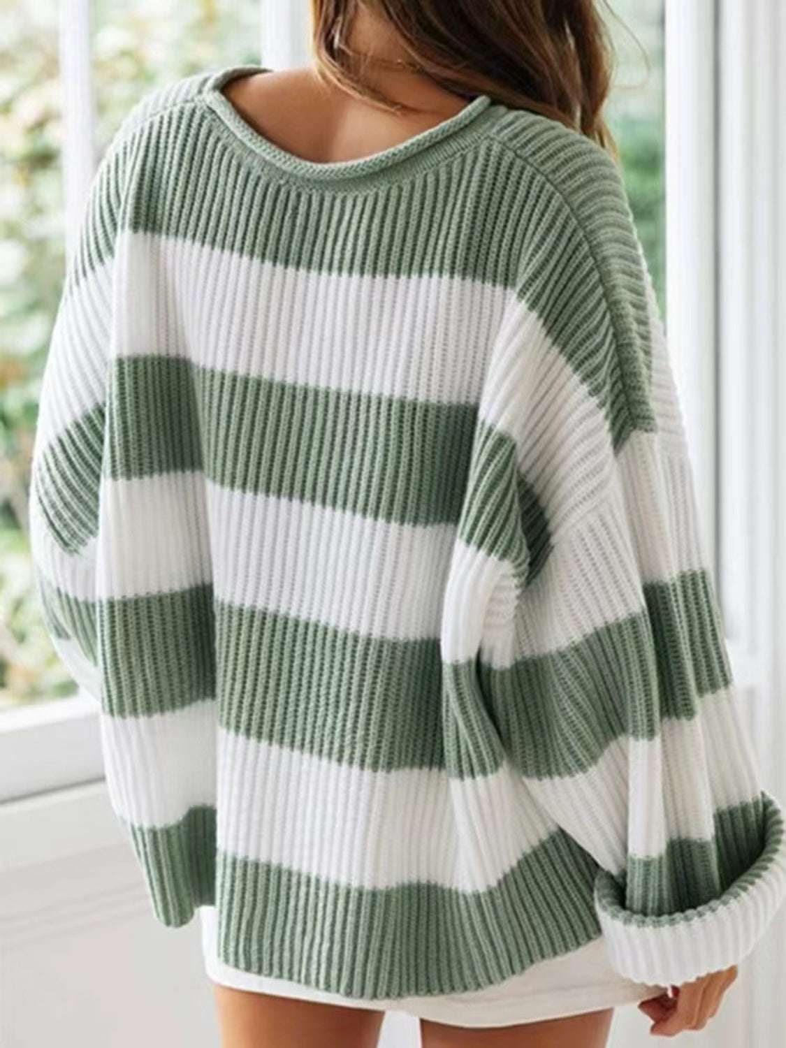 Round neck long sleeve sweater in green and white stripes, slightly stretchy polyester material.