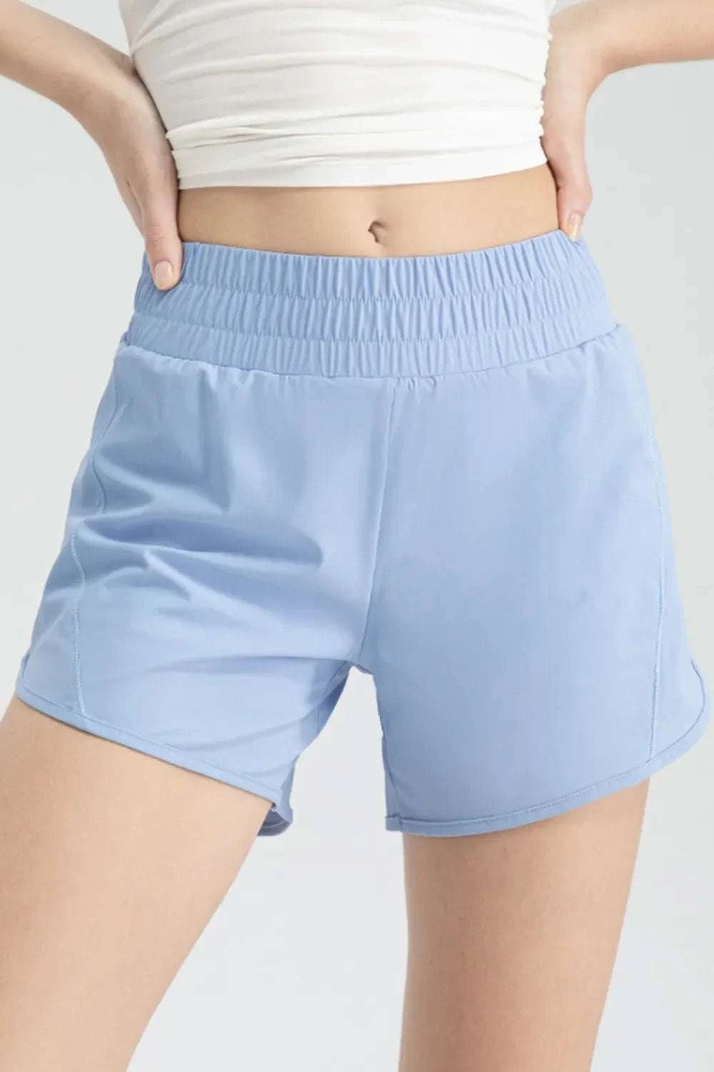 Elastic waist active shorts in light blue with moderate stretch.