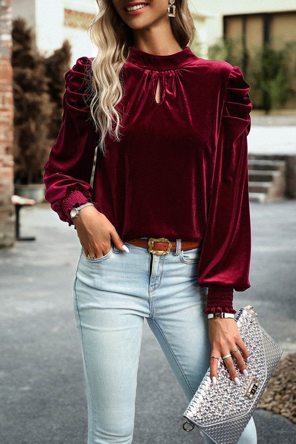 Mock neck velvet fabric long sleeve blouse with tie detail, styled with light denim jeans.