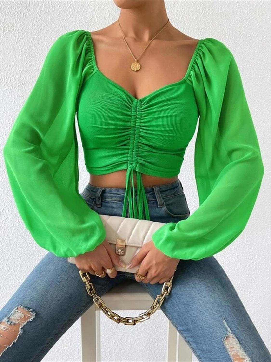 Green drawstring sweetheart neck cropped top with long sleeves.