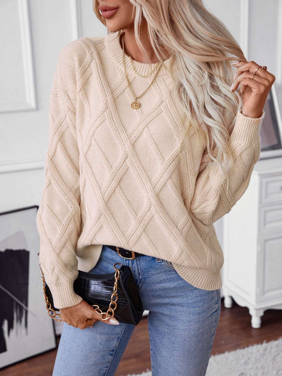 Geometric round neck long sleeve sweater with cable knit design in beige.
