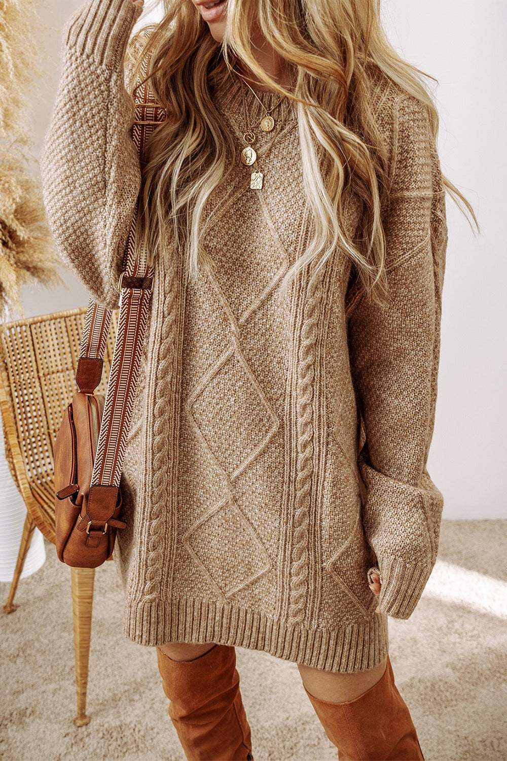 Cable-knit round neck sweater dress in beige, featuring a slightly stretchy fit and detailed pattern.