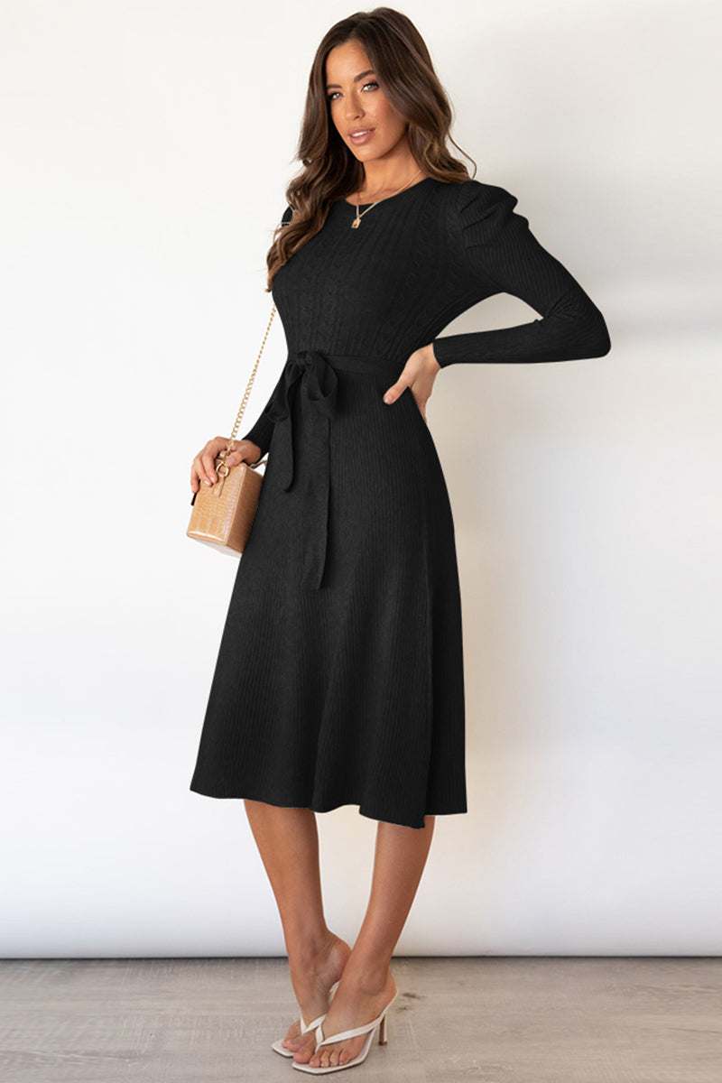 Round neck long sleeve tie waist sweater dress in black.