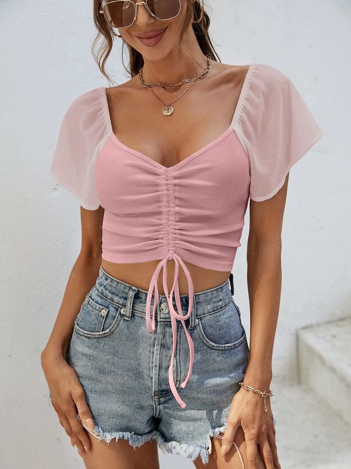 Pink drawstring short sleeve crop top with moderate stretch.