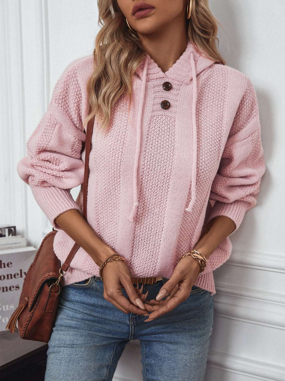 Drawstring long sleeve hooded sweater with decorative button in pink.