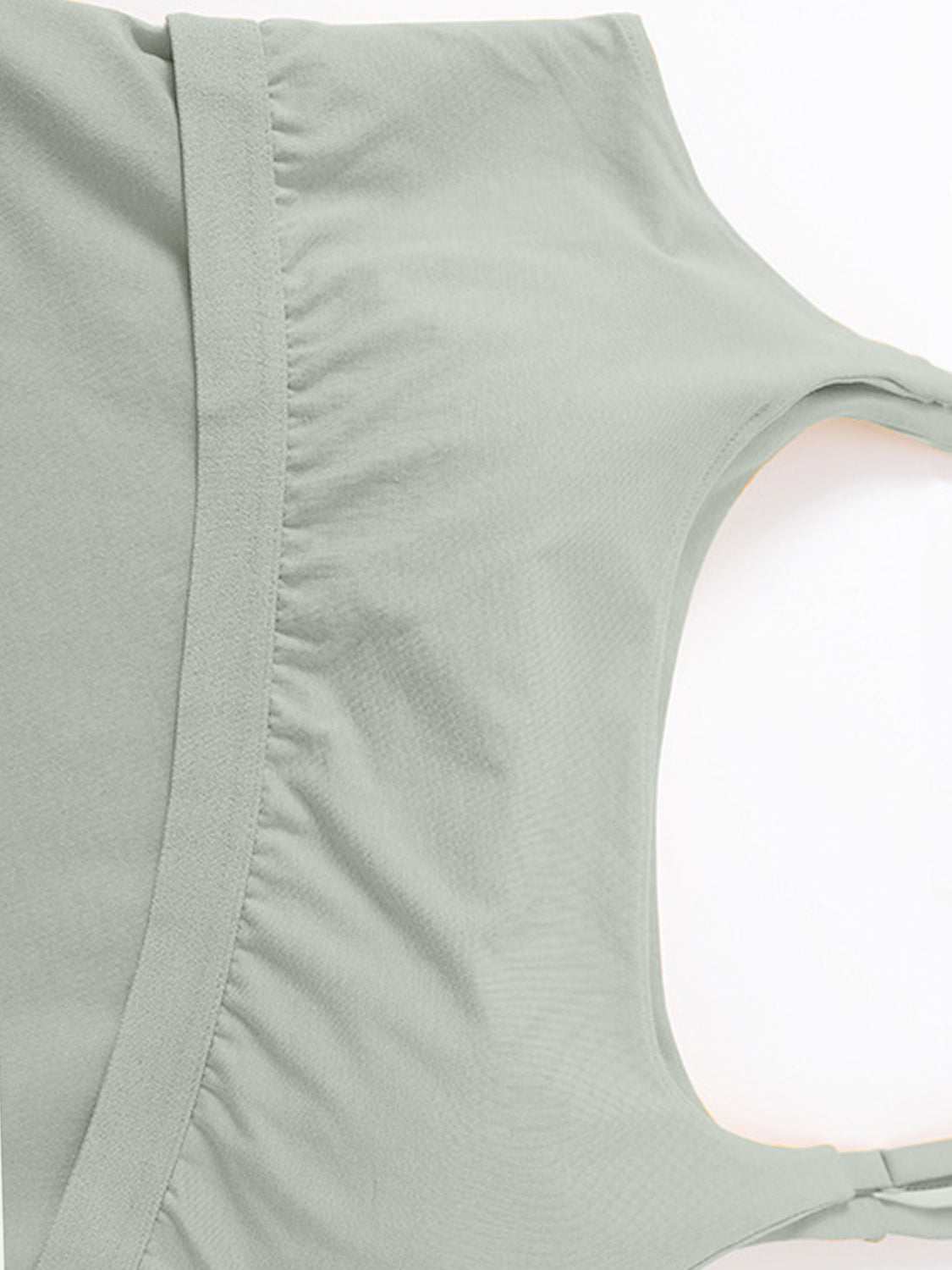 Scoop neck cropped cami with chest pads in light green, highly stretchy fabric.