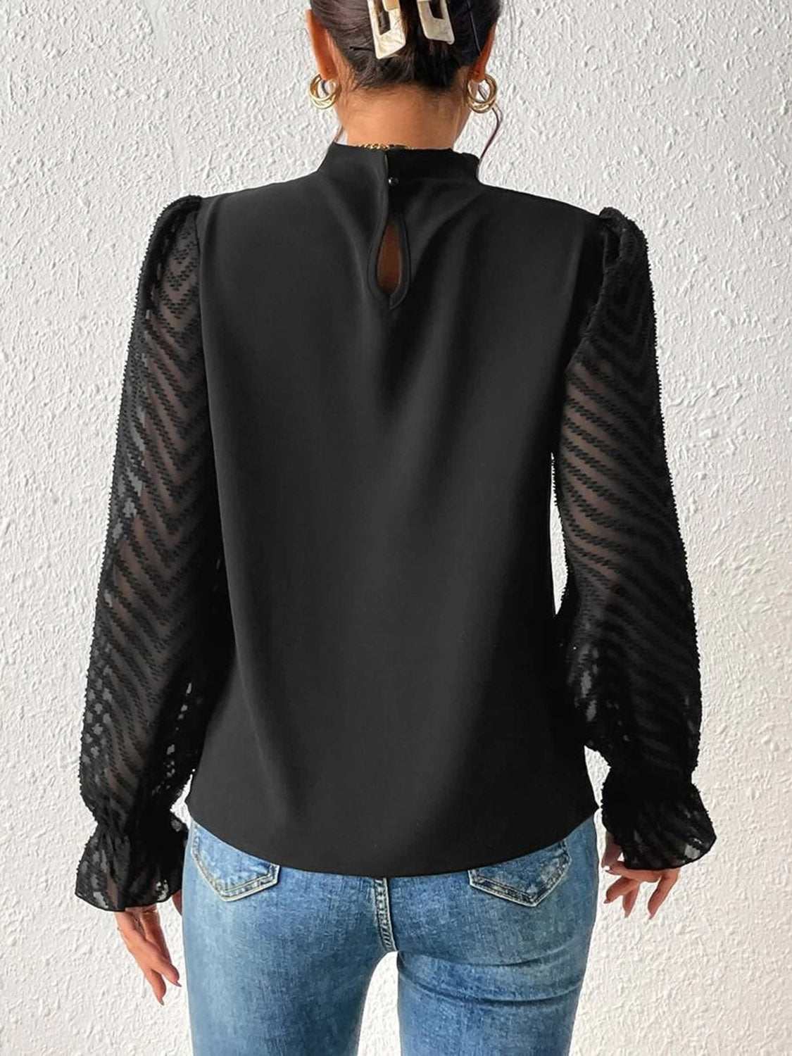 Mock neck flounce sleeve blouse with semi-sheer ruffled sleeves, back view.