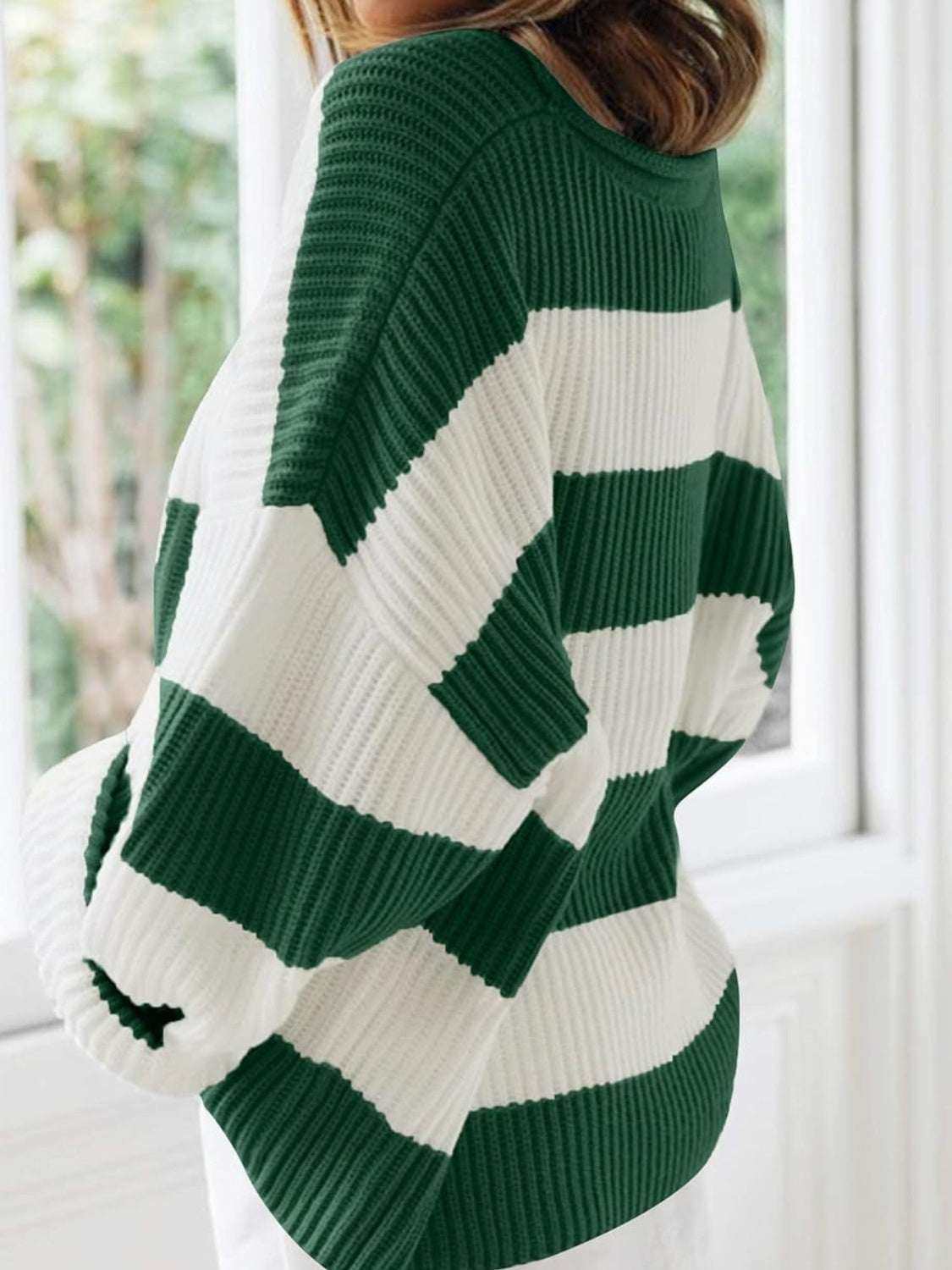 Round neck long sleeve sweater in green and white stripes, slightly stretchy polyester.