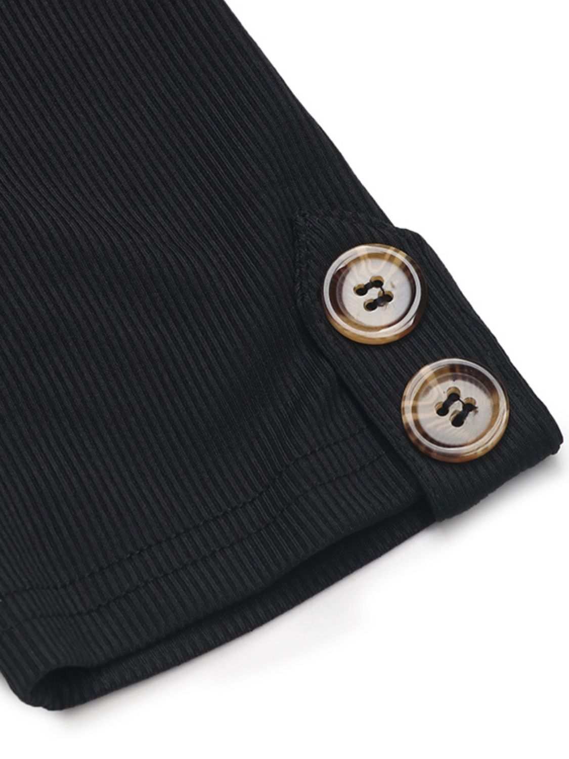 Close-up of black ribbed fabric with button details on the Perfee Tied Printed Mock Neck Dress.