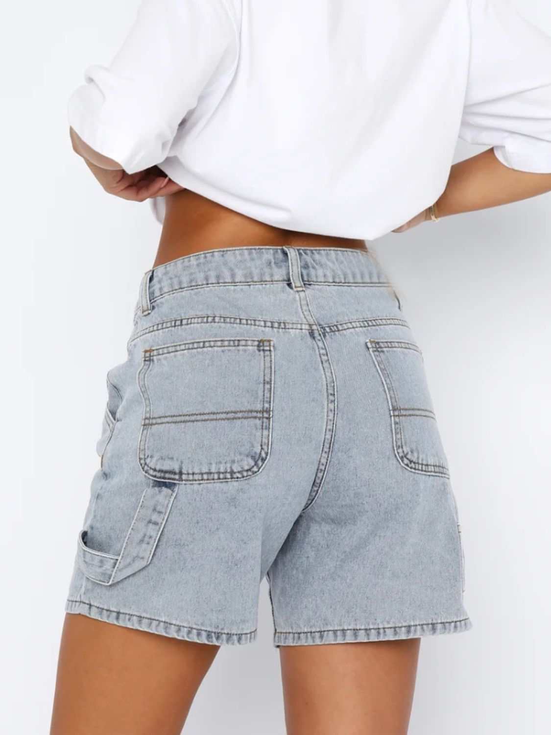 Washed high rise denim shorts with pockets, no stretch; back view.