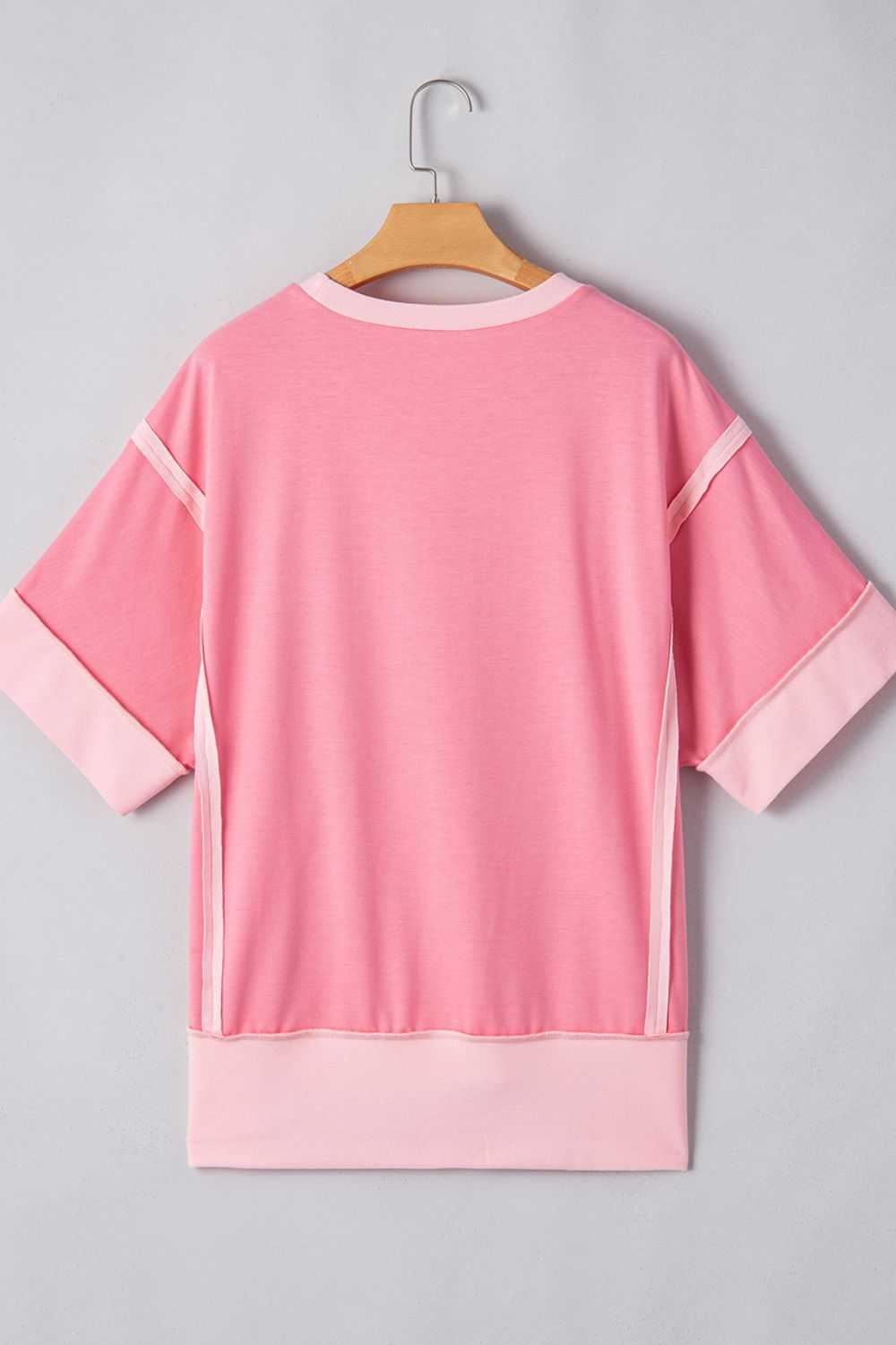 Pink short sleeve t-shirt with exposed seams, featuring an Easter egg design.