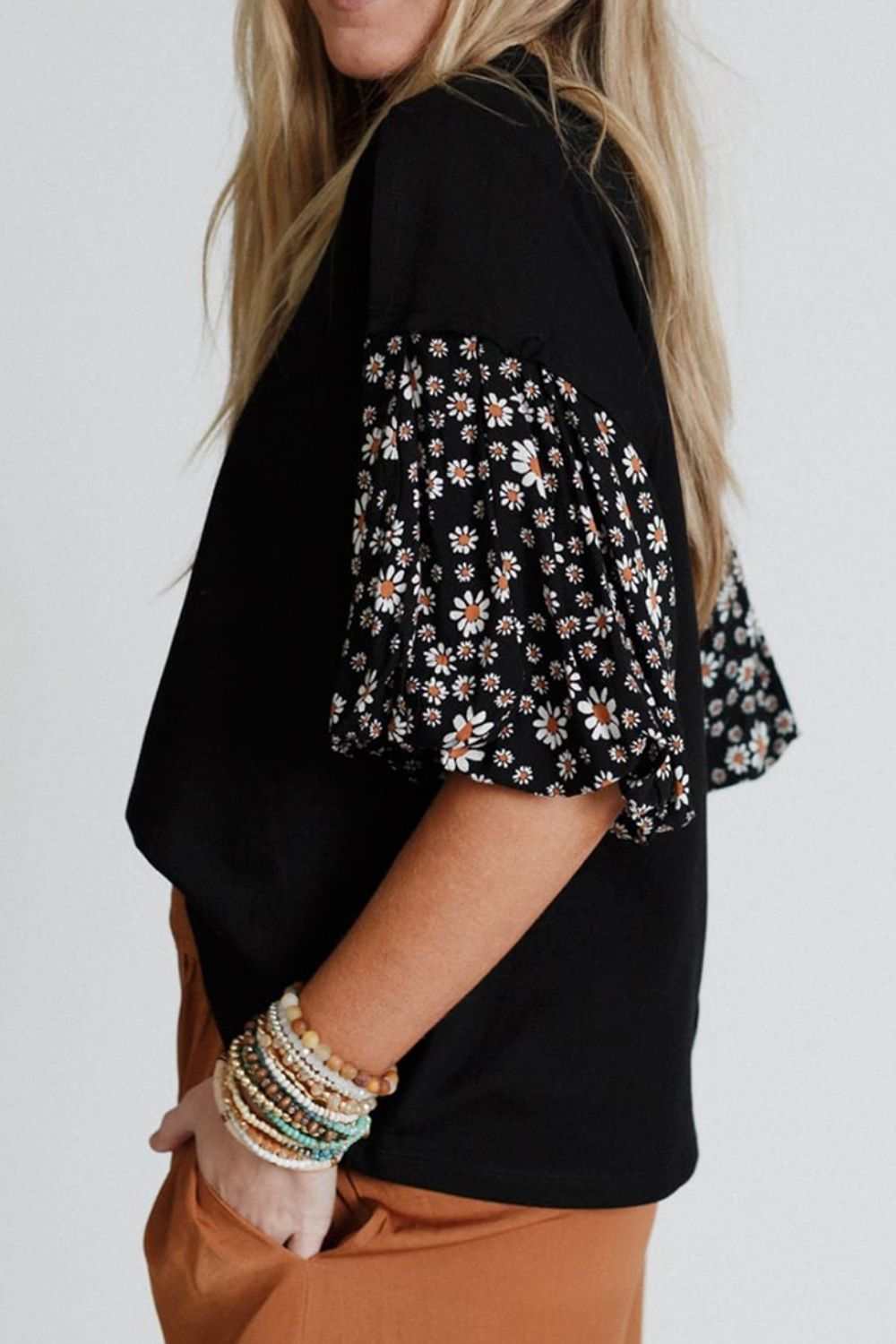 Contrast floral puff sleeve oversized top with black body and floral sleeves.
