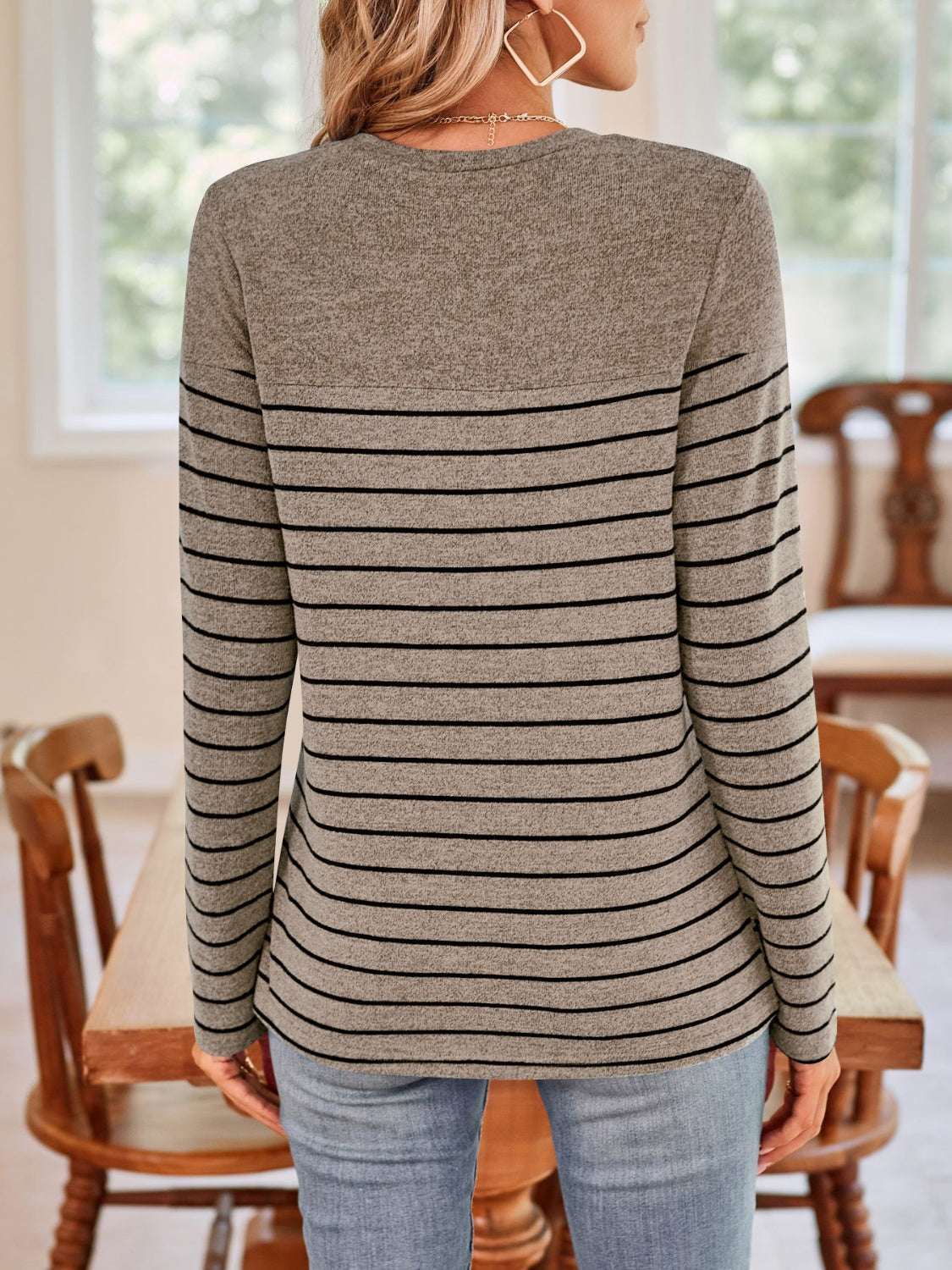 Lovelet Quarter Button Striped Round Neck Long Sleeve T-Shirt in gray with black stripes, showcased in a casual indoor setting.