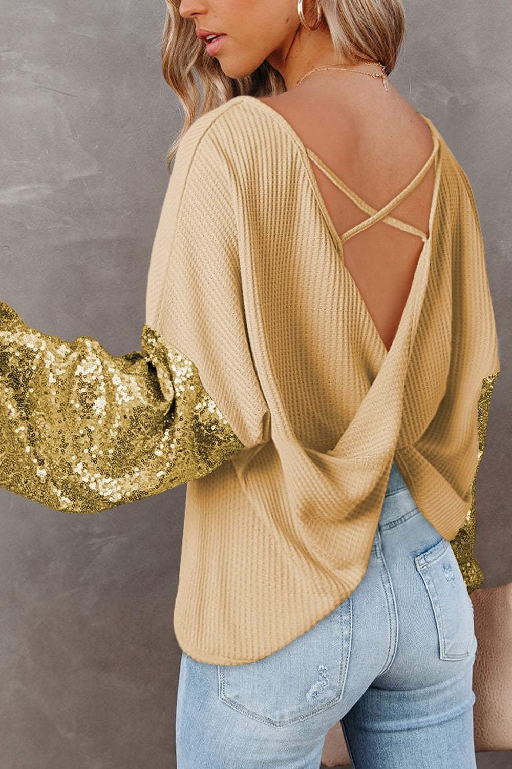 Sequin Waffle-Knit Blouse with gold sequin sleeves and an open back design.