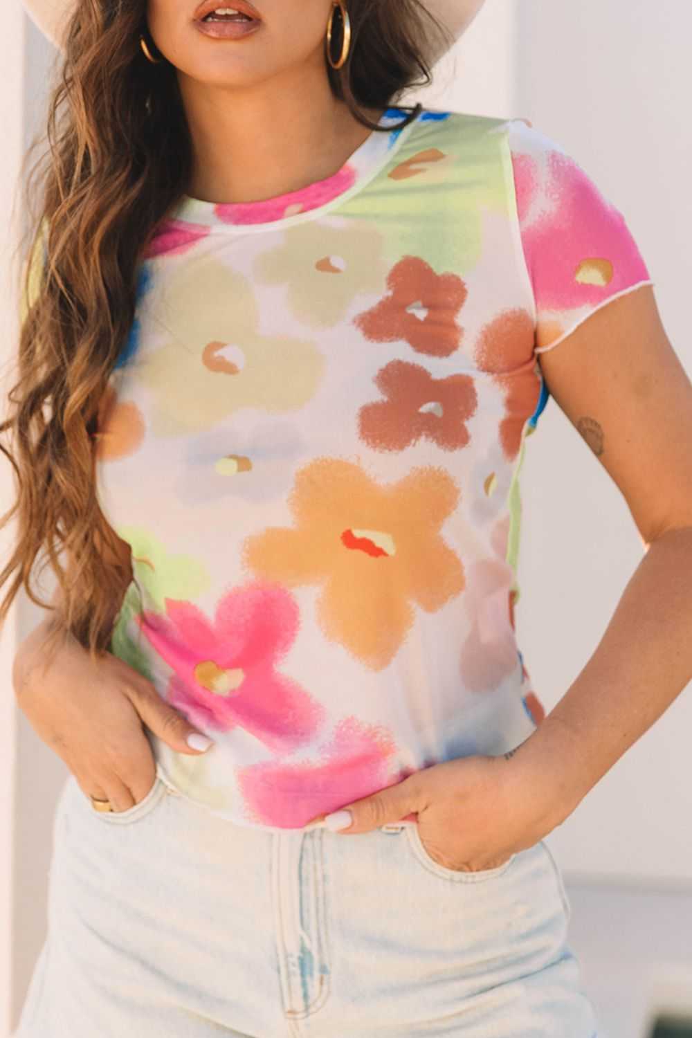 Printed round neck short sleeve blouse with colorful floral design.