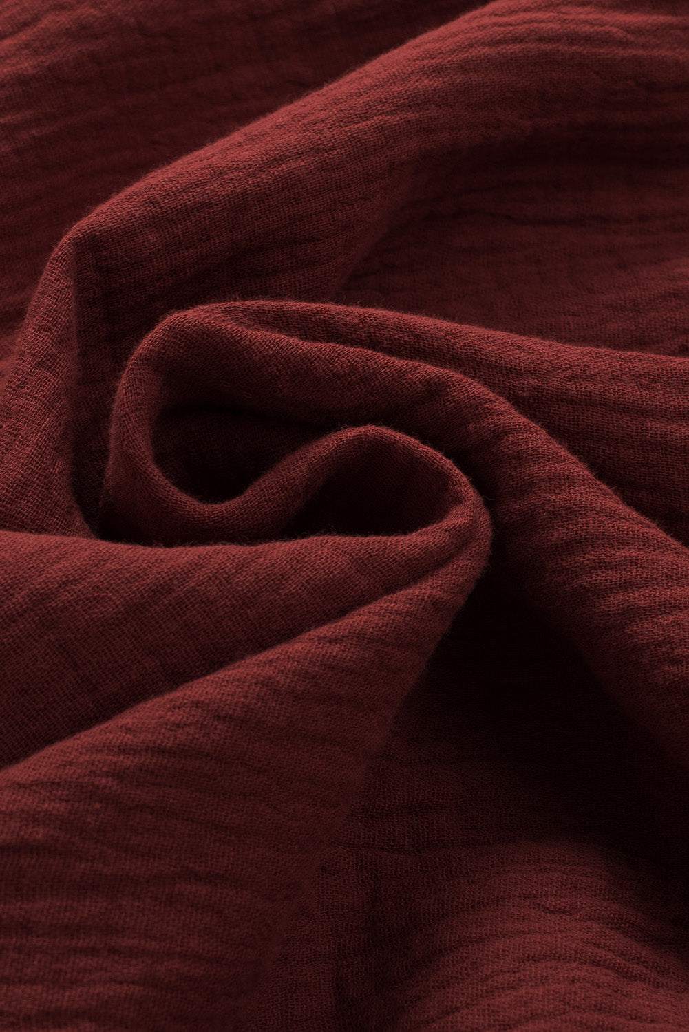 Rich textured fabric of a Dropped Shoulder V-Neck Blouse in solid color.