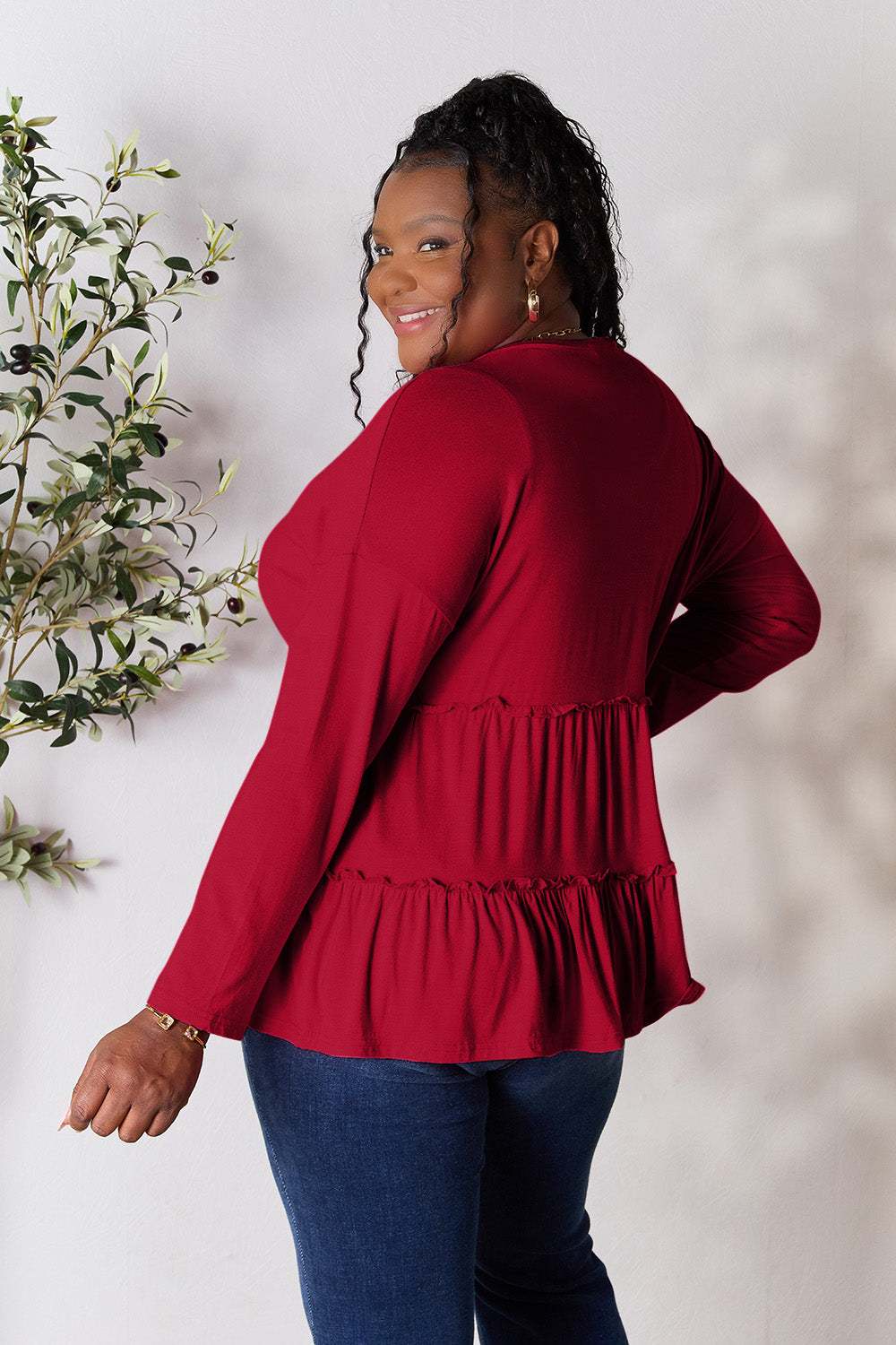 Ruffled hem long sleeve blouse with half button design in red.
