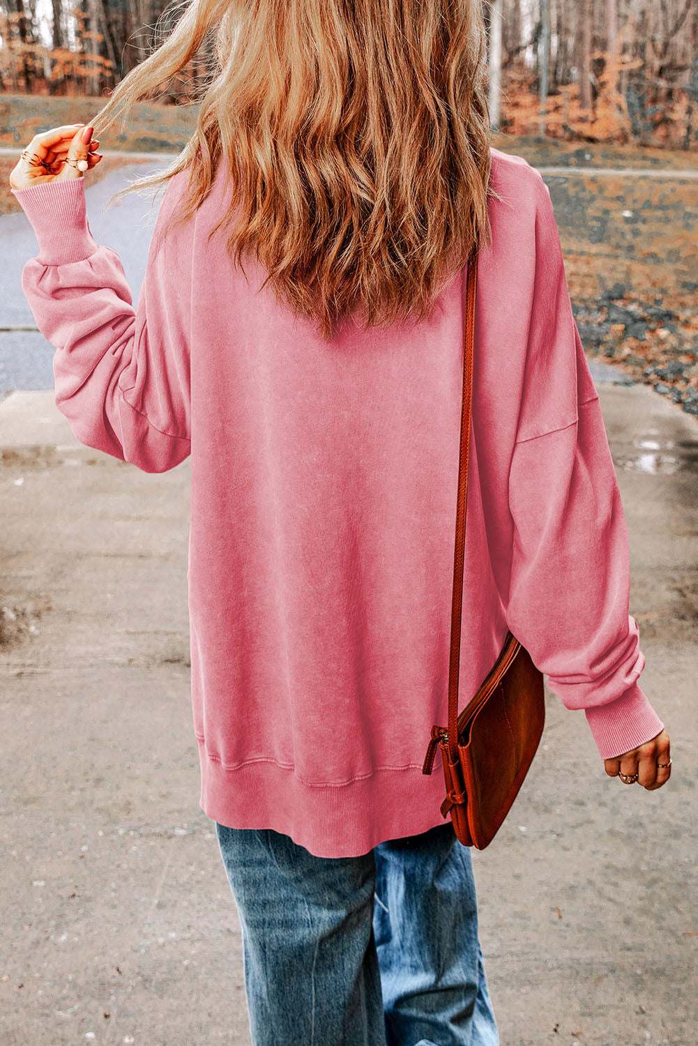 Casual long sleeve pink dropped shoulder blouse with round neck, paired with jeans.