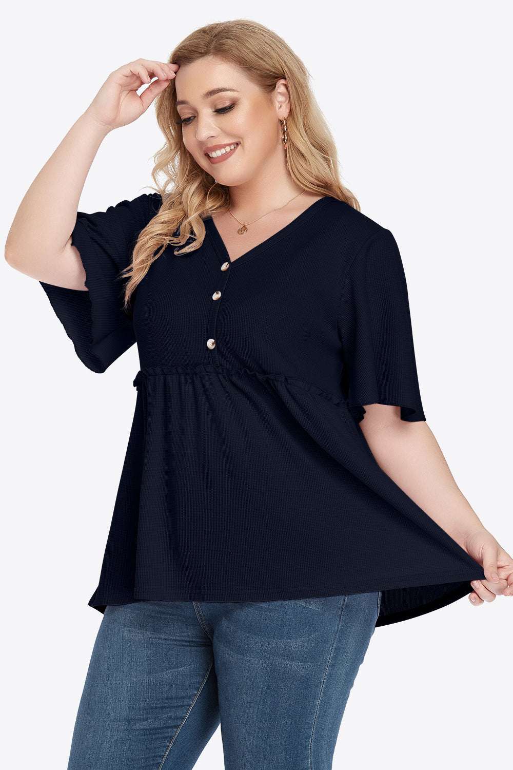 Plus size v-neck frill trim babydoll blouse with button detail and flutter sleeves.
