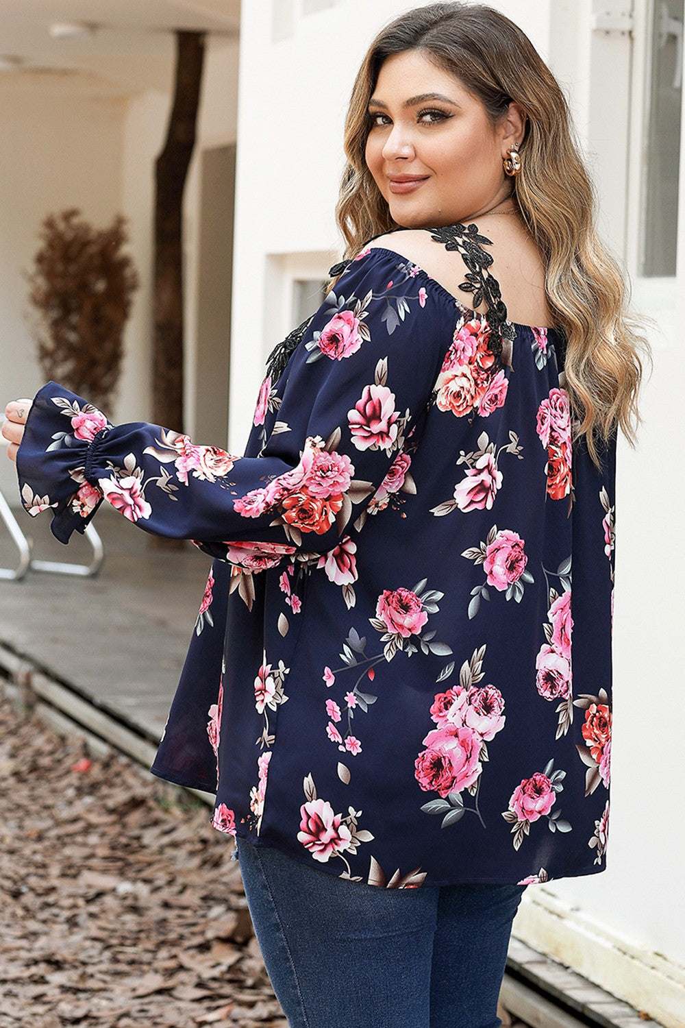 Plus size floral flounce sleeve blouse in navy with pink and red flowers.