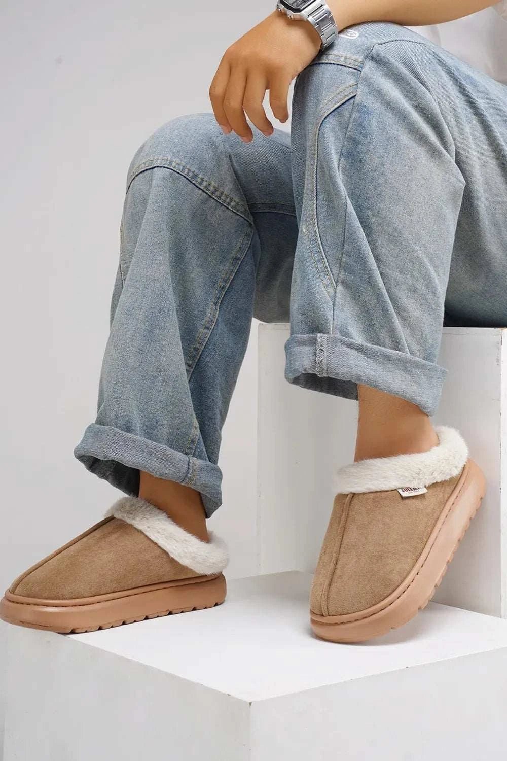 Furry round toe platform slippers with faux fur and EVA sole.