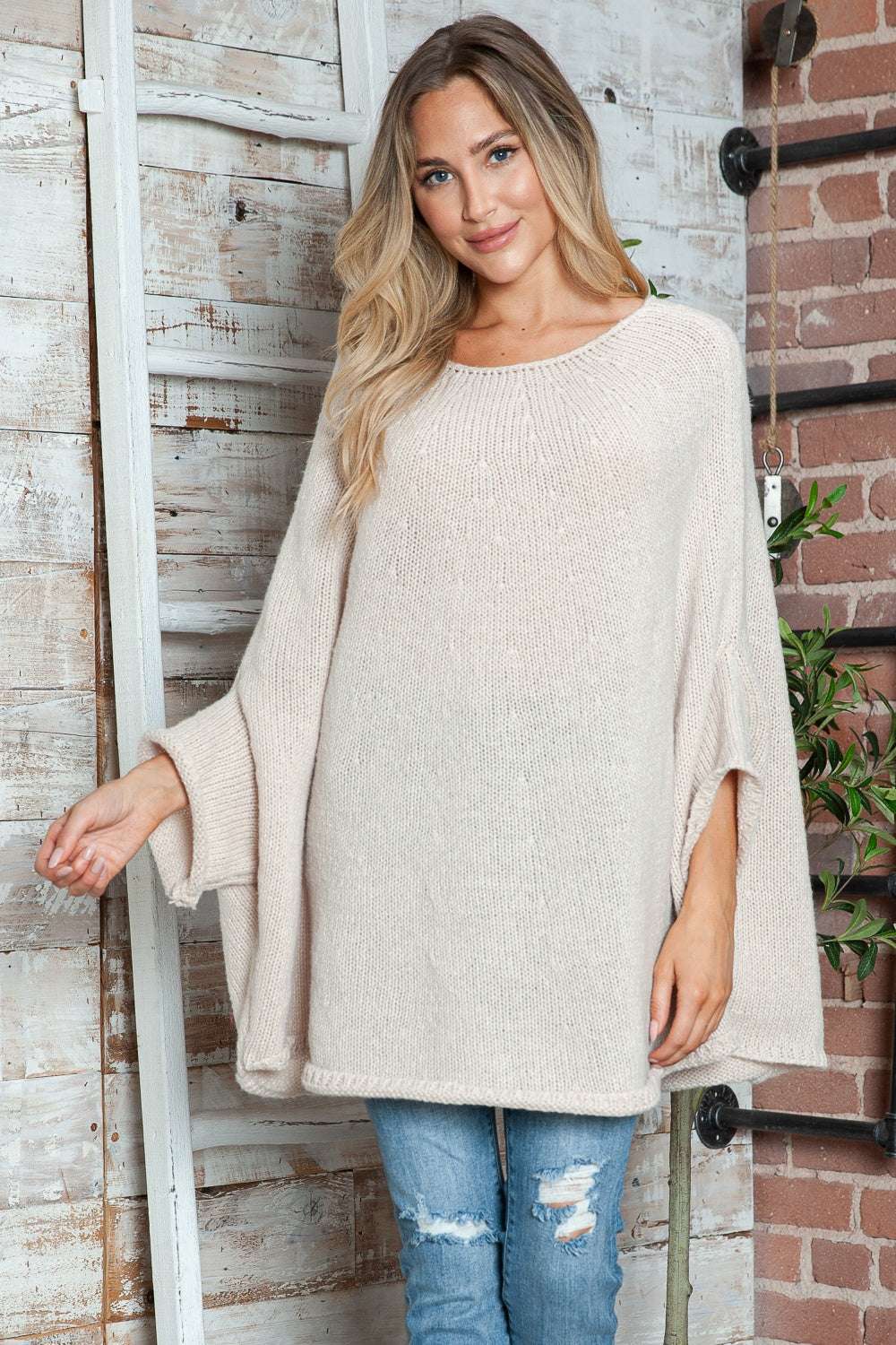 Round neck batwing sleeve sweater in beige, slightly stretchy polyester material.