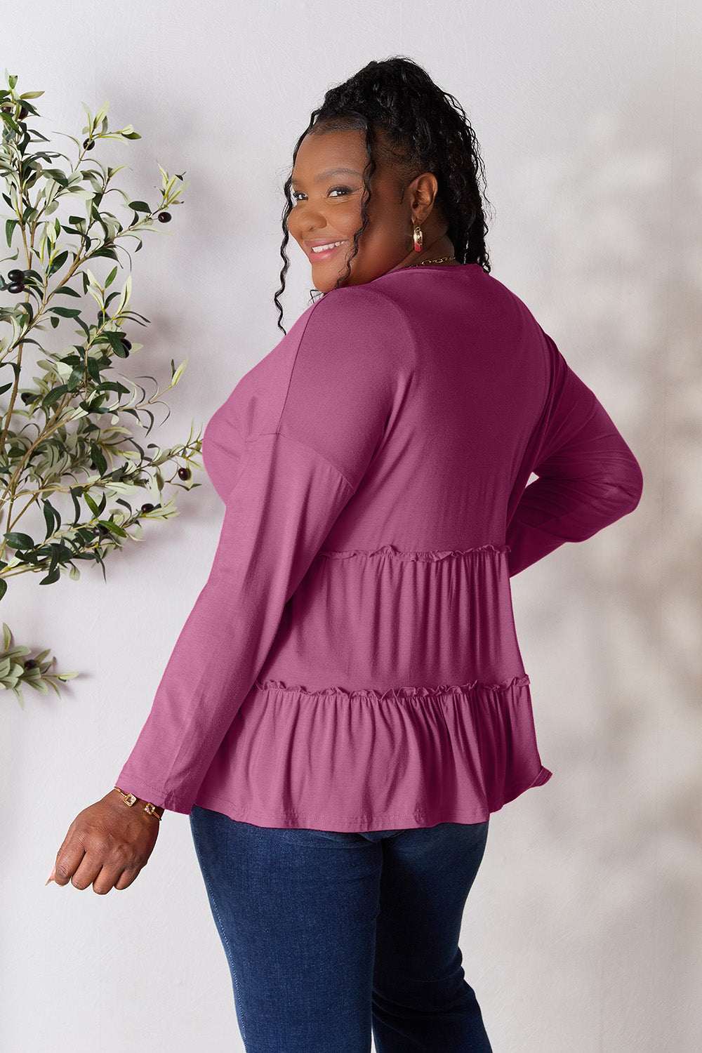 Half button long sleeve ruffle hem blouse in magenta, showcasing back details and relaxed fit.