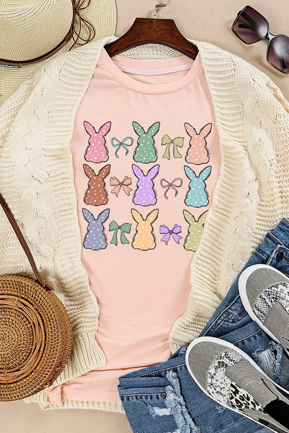 Dotty Bunny Bow Graphic Short Sleeve T-Shirt with bunny and bow print, styled with a cardigan, hat, sunglasses, and casual shoes.