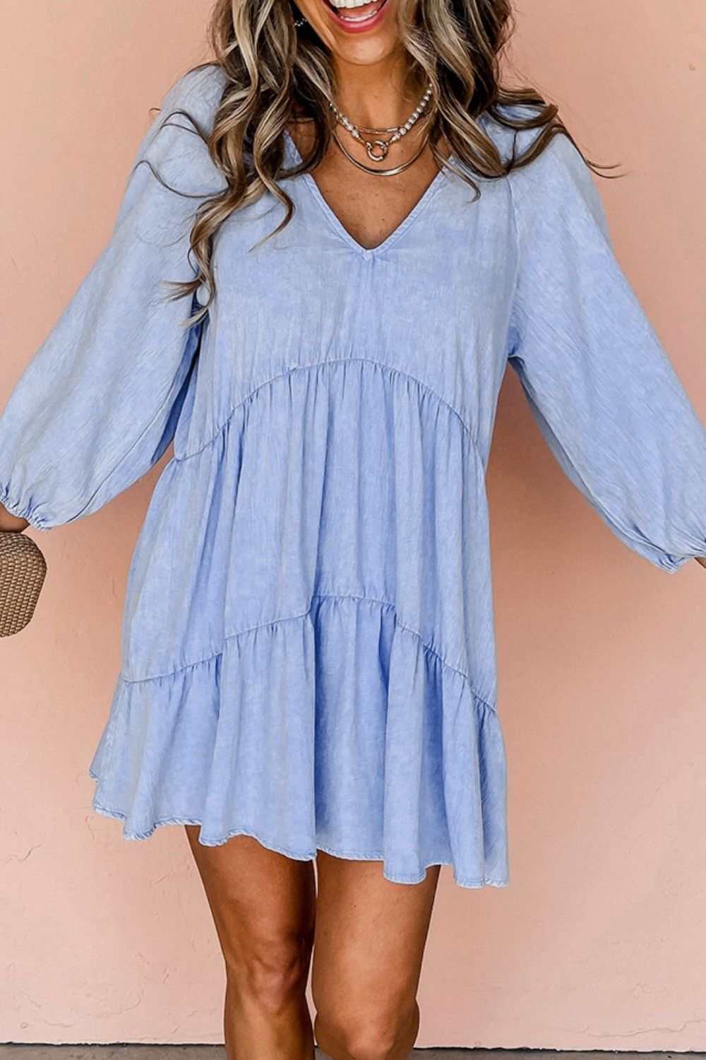 V-Neck tiered ruffled hem mini dress in light blue with long sleeves.