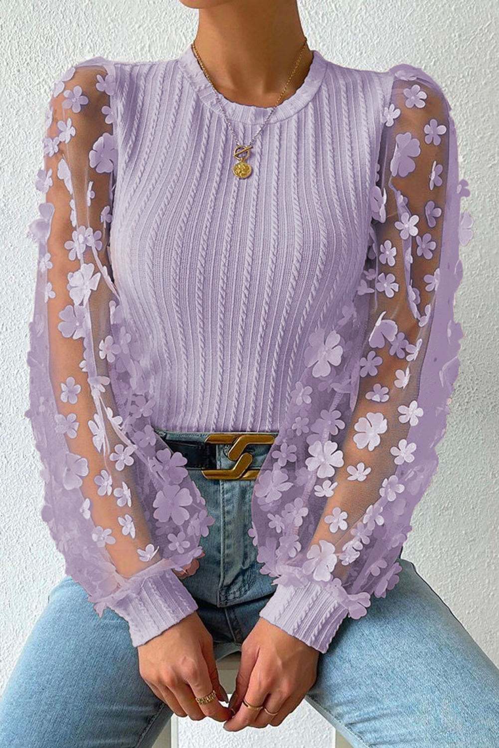 Textured applique long sleeve blouse with floral mesh sleeves and cable-knit design.
